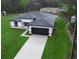 Aerial view of a modern home with a large driveway and well-maintained lawn at 2252 Sw 168Th Loop, Ocala, FL 34473