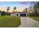 Modern home featuring a spacious lawn, two-car garage, and contemporary black and white design at 2252 Sw 168Th Loop, Ocala, FL 34473