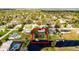 Aerial view of a home with canal access and private dock surrounded by mature trees and lush landscape at 2431 Westwood Dr, Longwood, FL 32779