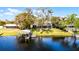Backyard waterfront view of the property, including boat dock, expansive lawn, and screened porch at 2431 Westwood Dr, Longwood, FL 32779