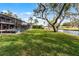 Expansive backyard featuring a screened-in pool area, lush lawn and a tranquil canal view at 2431 Westwood Dr, Longwood, FL 32779