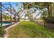 The backyard boasts lush grass, a partial view of the canal, and mature trees at 2431 Westwood Dr, Longwood, FL 32779