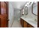 Elegant bathroom featuring double sinks, marble counters, and glass-enclosed shower at 2431 Westwood Dr, Longwood, FL 32779