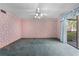 Cozy room with vintage wallpaper, carpet, and an access to a screened in outdoor balcony at 2431 Westwood Dr, Longwood, FL 32779