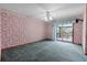 Bedroom features wallpaper, a ceiling fan, and sliding glass doors to the lanai at 2431 Westwood Dr, Longwood, FL 32779
