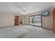 Bedroom with plush carpet, wood trim, and a sliding glass door to the balcony at 2431 Westwood Dr, Longwood, FL 32779