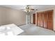 Bedroom with light beige walls, built-in closet, ceiling fan, and carpeted floors at 2431 Westwood Dr, Longwood, FL 32779