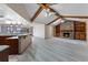 Open-concept kitchen and living area features wood beam vaulted ceilings and a brick fireplace at 2431 Westwood Dr, Longwood, FL 32779