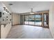 Bright living room with laminated floors and sliding glass doors offering pool views at 2431 Westwood Dr, Longwood, FL 32779
