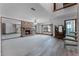 Bright living room features a brick fireplace, spiral staircase and mirror wall at 2431 Westwood Dr, Longwood, FL 32779