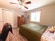 Comfortable bedroom featuring a ceiling fan, closet, and a window at 25704 Aberdovey Ave, Sorrento, FL 32776