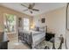 Cozy bedroom with neutral colors, ceiling fan and natural light at 2631 Captains Ct, Kissimmee, FL 34746