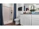 Clean bathroom design features a white vanity, granite countertop, and a shower with blue curtains, creating a refreshing space at 2660 Gouda Dr, Apopka, FL 32703