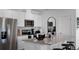 Modern kitchen features stainless steel appliances, granite countertops, and white cabinets at 2660 Gouda Dr, Apopka, FL 32703