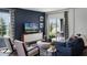 Beautifully decorated living room featuring stylish seating, a sleek entertainment unit, and a sliding glass door to the outdoors at 2660 Gouda Dr, Apopka, FL 32703