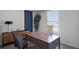 Well-lit office space featuring a modern desk, accent wall, and large window at 2660 Gouda Dr, Apopka, FL 32703