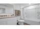 Bright bathroom featuring a white vanity with a granite countertop, a bathtub with a shower, and neutral-toned decor at 2664 Gouda Dr, Apopka, FL 32703