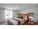 Inviting bedroom featuring a wooden bed frame, decorative shelving, and a large window for natural light at 2664 Gouda Dr, Apopka, FL 32703