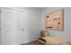 Cozy hallway with a light-colored door, modern art, a bench with a plush throw, and wood-look flooring at 2664 Gouda Dr, Apopka, FL 32703