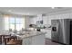 Bright kitchen features white cabinets, stainless steel appliances, and a granite island with seating at 2672 Gouda Dr, Apopka, FL 32703