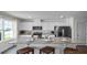 Bright kitchen features white cabinets, stainless steel appliances, and a granite island with seating at 2672 Gouda Dr, Apopka, FL 32703