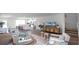 Open-concept living area with contemporary decor, natural light, and stylish furnishings at 2672 Gouda Dr, Apopka, FL 32703