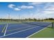 Multiple community tennis courts with nets and lighting, offering ample recreational space at 2672 Gouda Dr, Apopka, FL 32703