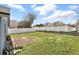 Large backyard featuring a well-maintained lawn and partial patio for outdoor activities and entertaining at 2740 Regency Oak Ln, Orlando, FL 32833