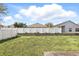 A spacious backyard featuring a well-maintained lawn, privacy fence, and room for outdoor activities and entertaining at 2740 Regency Oak Ln, Orlando, FL 32833