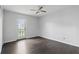 This bedroom features hardwood floors, a ceiling fan, and a door leading outside at 2740 Regency Oak Ln, Orlando, FL 32833