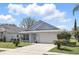Charming single-Gathering home with a well-maintained lawn, attached garage and manicured landscaping at 2740 Regency Oak Ln, Orlando, FL 32833