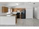Kitchen area featuring black appliances and wood cabinets, and gray wood-look flooring at 2740 Regency Oak Ln, Orlando, FL 32833