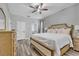 Comfortable bedroom with a queen sized bed, wood flooring, and neutral decor at 2801 Lido Key Ct, Kissimmee, FL 34747