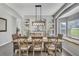 Dining room with a large table, decorative lighting, and built-in shelves at 2801 Lido Key Ct, Kissimmee, FL 34747