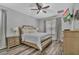 Comfortable main bedroom with a ceiling fan, wood-look floors, and a television mounted on the wall at 2801 Lido Key Ct, Kissimmee, FL 34747