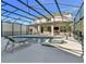 A backyard pool with a tanning ledge, hot tub, chairs and covered patio at 2801 Lido Key Ct, Kissimmee, FL 34747