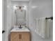 Stylish powder room featuring a modern vanity, a gold mirror, and a light fixture at 2801 Lido Key Ct, Kissimmee, FL 34747