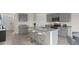Modern eat-in kitchen with gray cabinets, granite countertops, stainless steel appliances, and a large island at 2936 Moulin Rd, Davenport, FL 33837