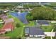 Aerial view of a beautiful suburban home with a screened pool and a tranquil lake view at 3180 Pawleys N Loop, St Cloud, FL 34769