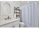 Bathroom featuring a vanity with white marble countertops and a blue and white striped shower curtain at 3180 Pawleys N Loop, St Cloud, FL 34769