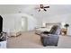 Spacious bedroom with a ceiling fan, large bed, TV, sitting area, and carpeted floors at 3180 Pawleys N Loop, St Cloud, FL 34769