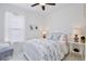 Bright bedroom with a white wooden bed frame, neutral decor, and natural light at 3180 Pawleys N Loop, St Cloud, FL 34769