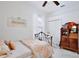 Cozy bedroom with bed, rocking chair, white trim, and natural light at 3180 Pawleys N Loop, St Cloud, FL 34769