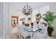 Elegant dining room featuring a glass-top table, stylish chandelier, and abundant natural light at 3180 Pawleys N Loop, St Cloud, FL 34769