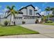 Attractive home with a three-car garage, manicured lawn, and lush landscaping, creating inviting curb appeal at 3180 Pawleys N Loop, St Cloud, FL 34769