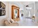 Bright foyer with tile flooring, a decorative mirror and stylish furnishings at 3180 Pawleys N Loop, St Cloud, FL 34769