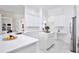 Bright kitchen featuring white cabinets, quartz countertops, and stainless steel appliances at 3180 Pawleys N Loop, St Cloud, FL 34769