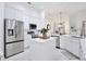 Modern kitchen with white cabinets, stainless steel appliances, and a center island at 3180 Pawleys N Loop, St Cloud, FL 34769
