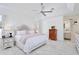 Bright main bedroom featuring a tray ceiling, ceiling fan, and light neutral decor at 3180 Pawleys N Loop, St Cloud, FL 34769