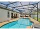 Stunning backyard with a screened-in pool, hot tub, and outdoor seating area under a gazebo at 3180 Pawleys N Loop, St Cloud, FL 34769